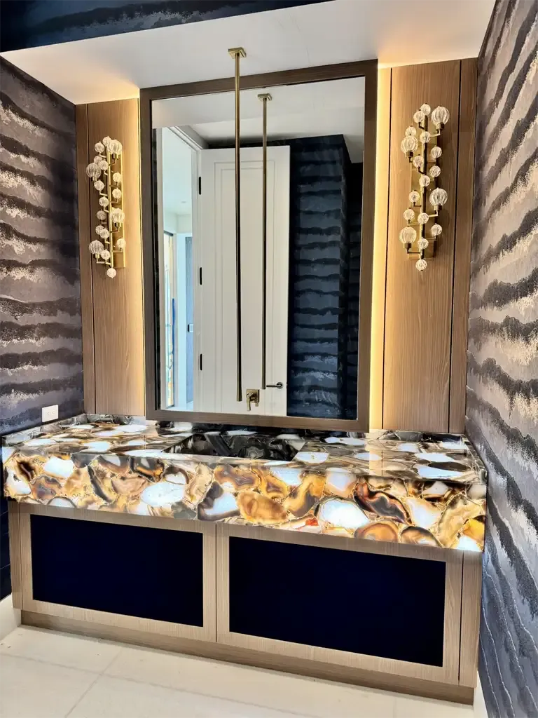 Luxury bathroom vanity with backlit agate stone countertop and custom wood cabinets by Kitchen & Bath Studios Coconut Creek.