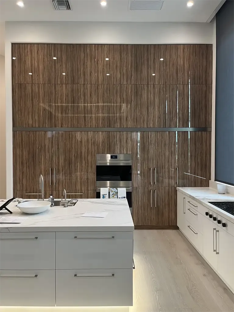 Sleek vertical grain wood kitchen cabinetry by Kitchen & Bath Studios Inc