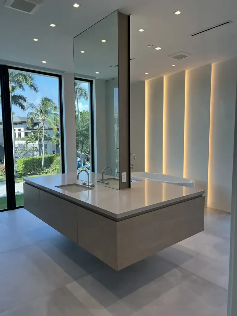 Luxury floating island vanity and freestanding tub design by Kitchen & Bath Studios Inc.