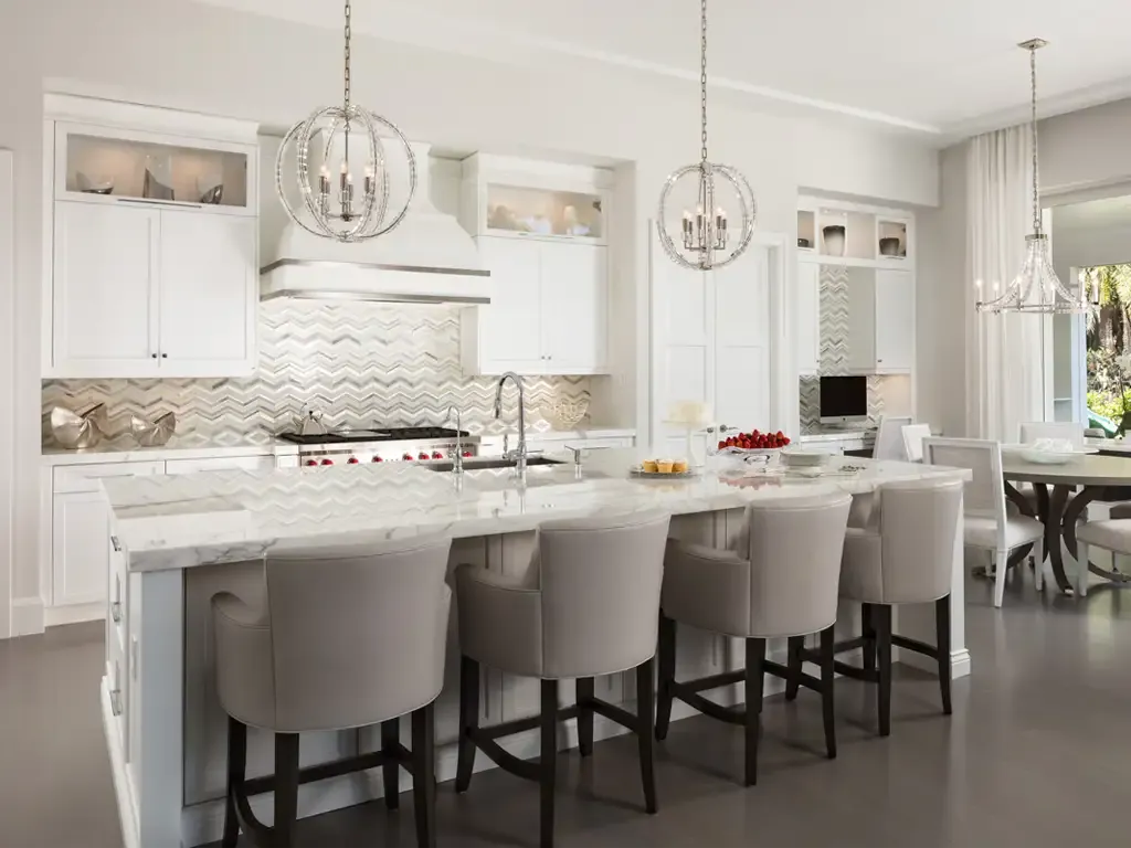 White transitional kitchen with chevron tile by Kitchen & Bath Studios Inc.