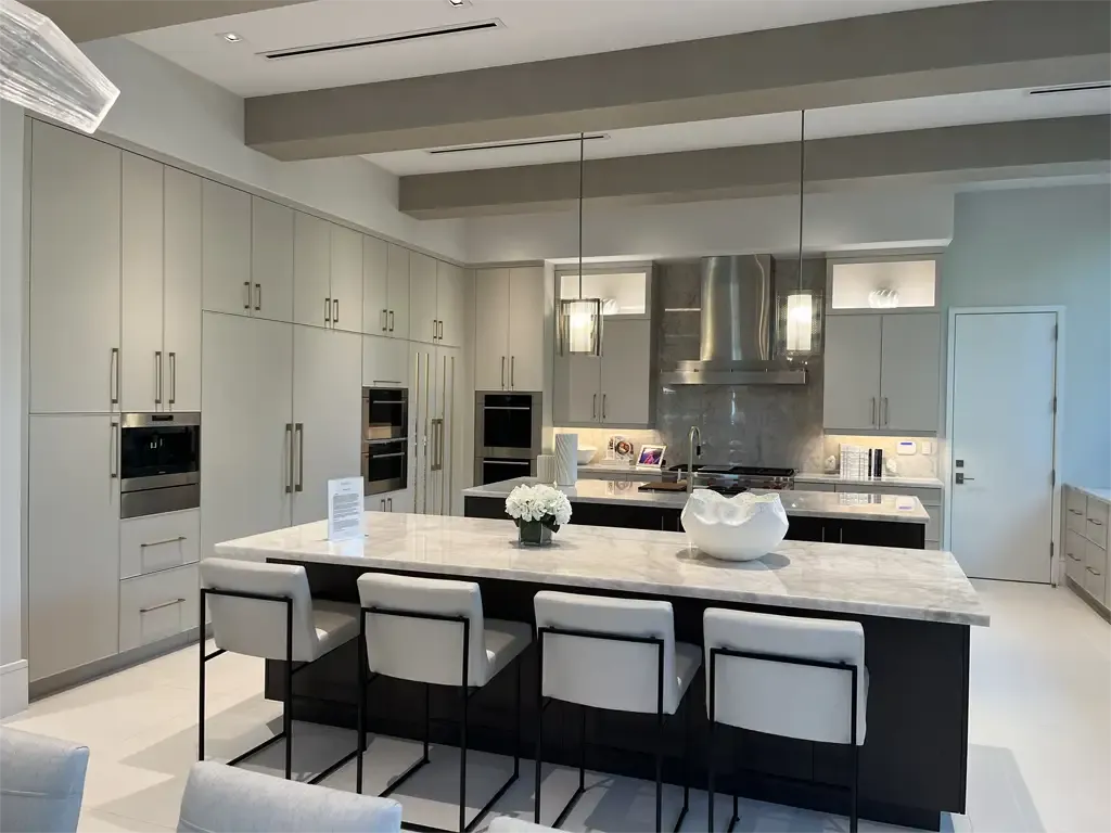 Double island kitchen with modern ceiling beams by Kitchen & Bath Studios Inc