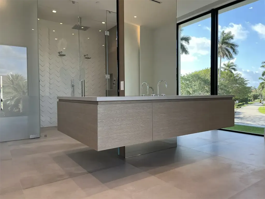 Modern floating wood bathroom vanity design by Kitchen & Bath Studios Inc.