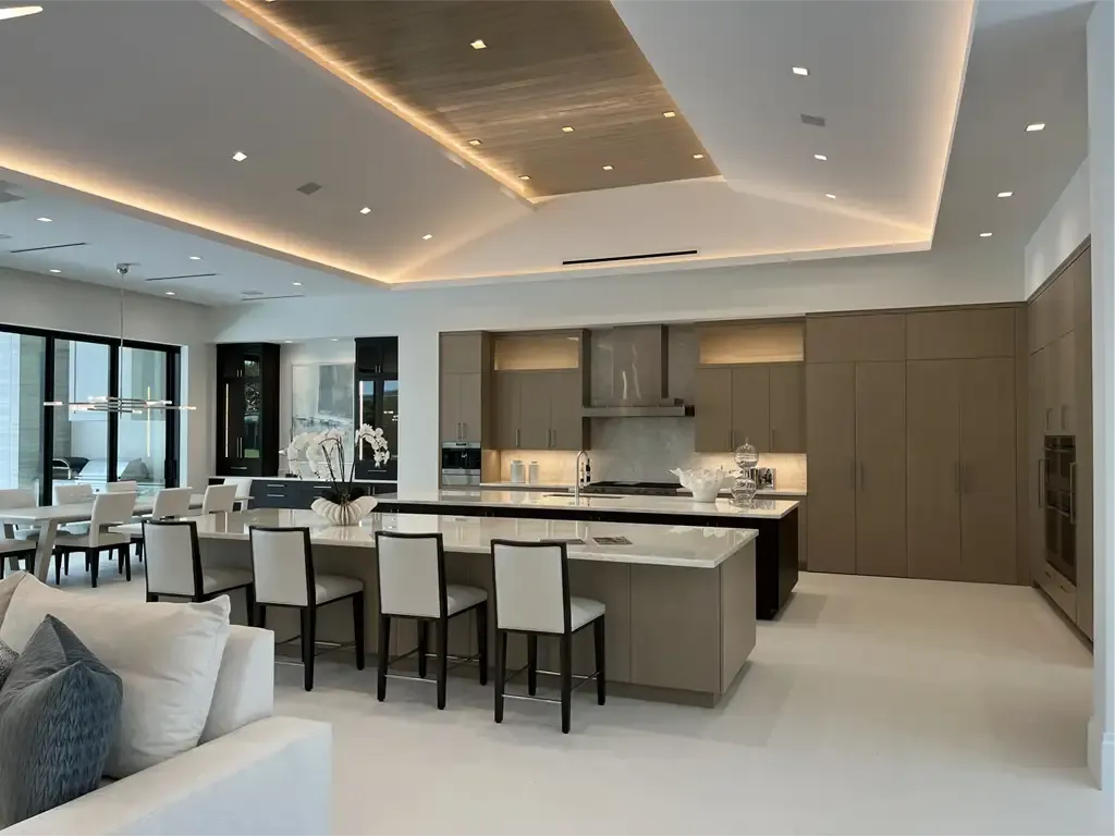 Expansive taupe kitchen with tray ceiling by Kitchen & Bath Studios Inc.