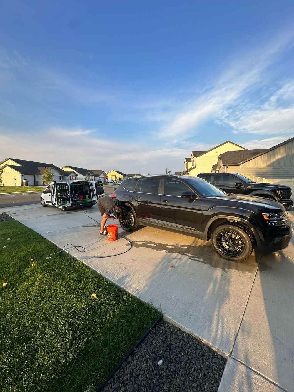 Clean black pickup truck in a driveway after an OG Pro Detail mobile service