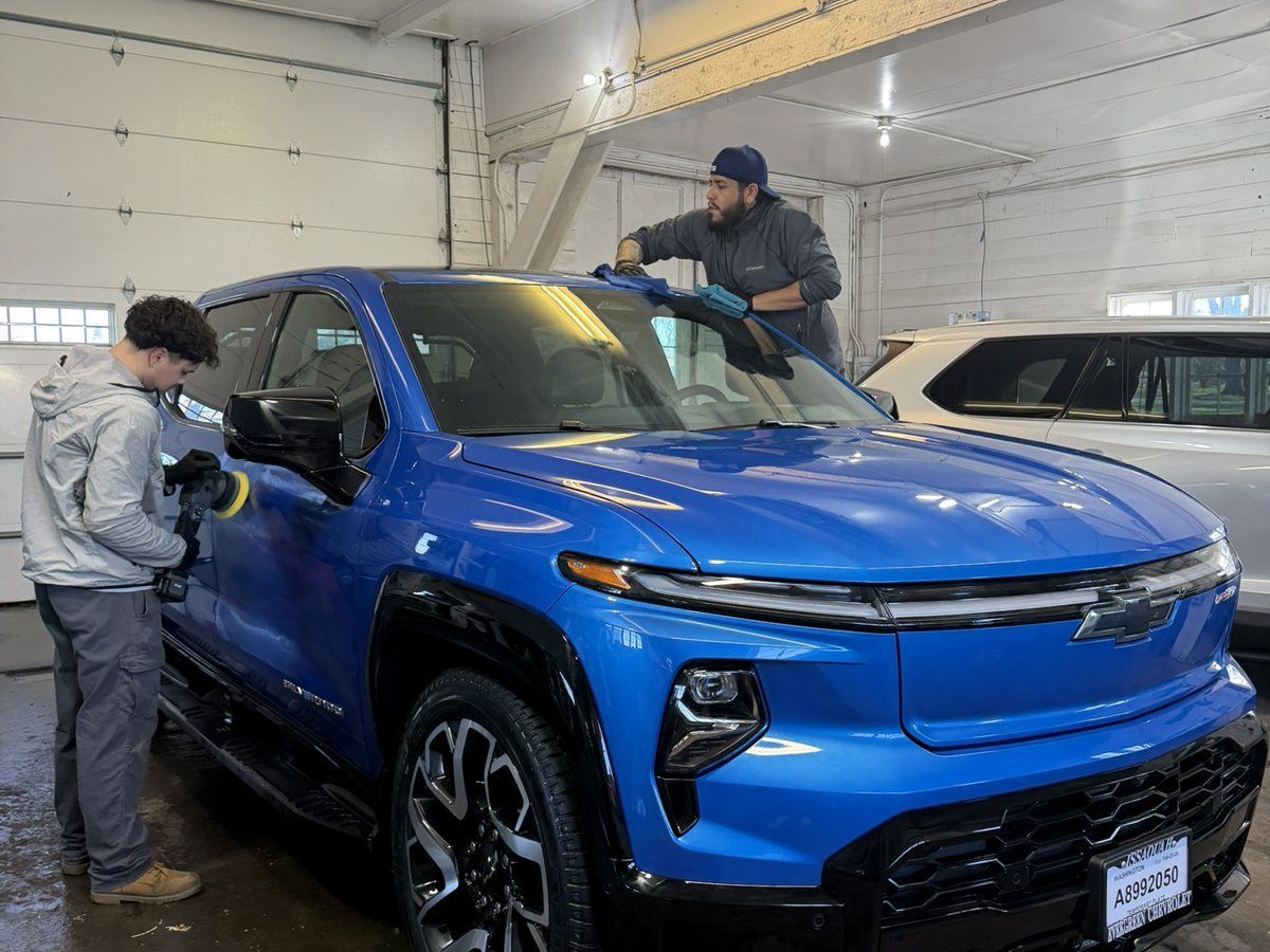 OG Pro Detail team polishing a blue Chevrolet before ceramic coating