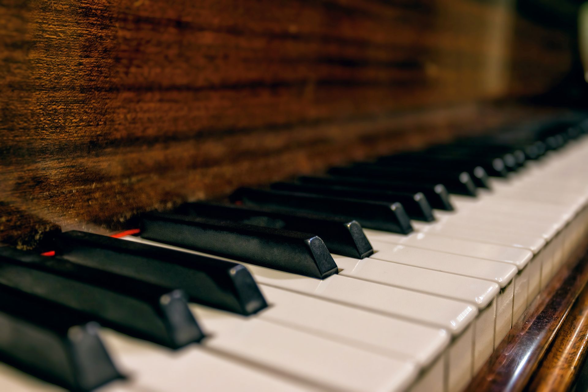 Close-up of piano keys on a polished wooden piano