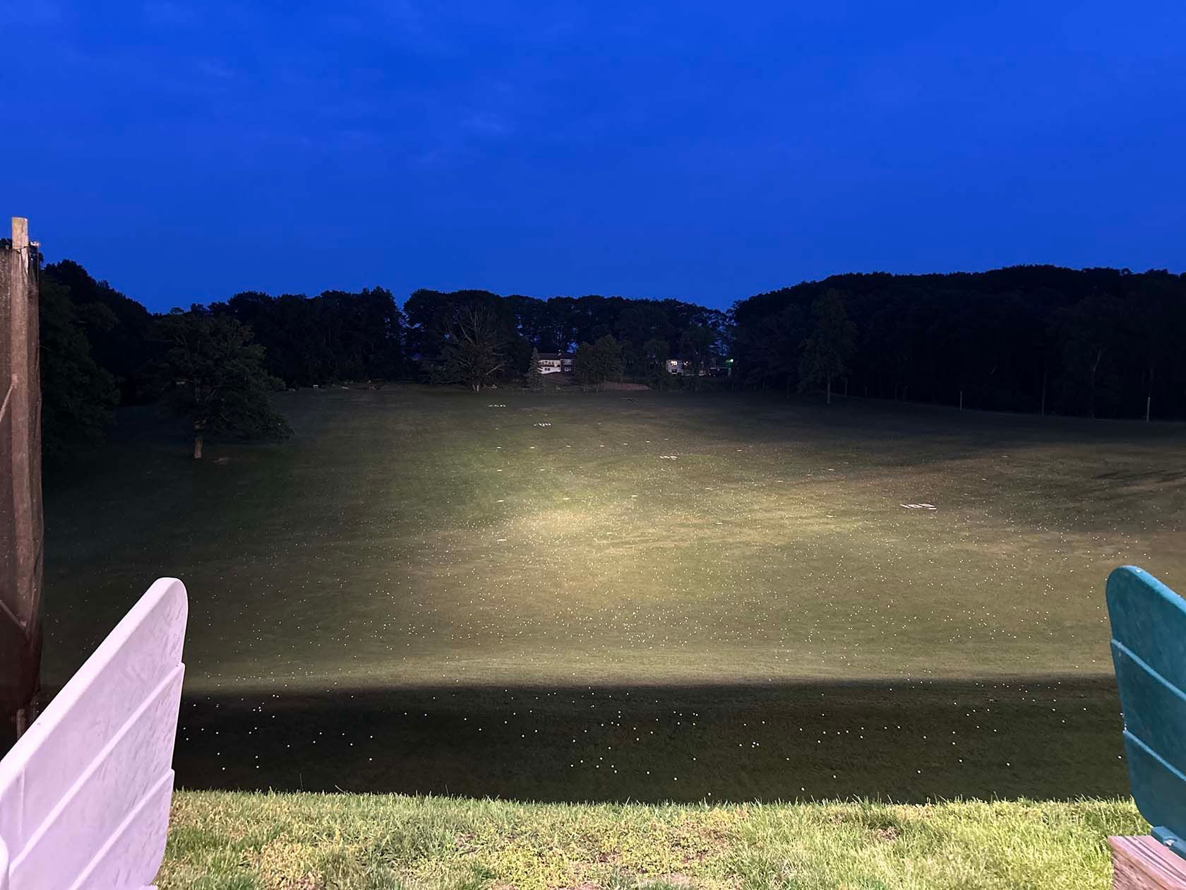 Driving range at night with golf balls