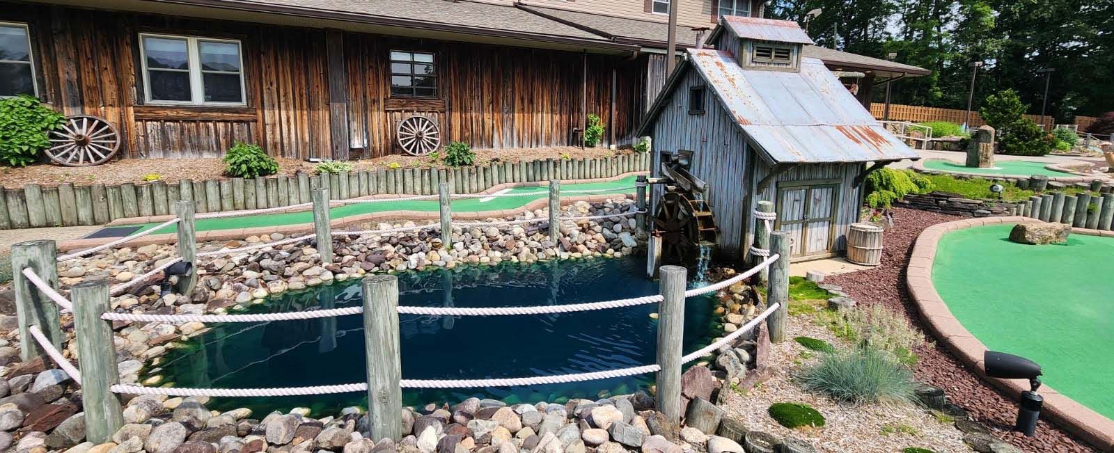 Golf course with water mill and pond