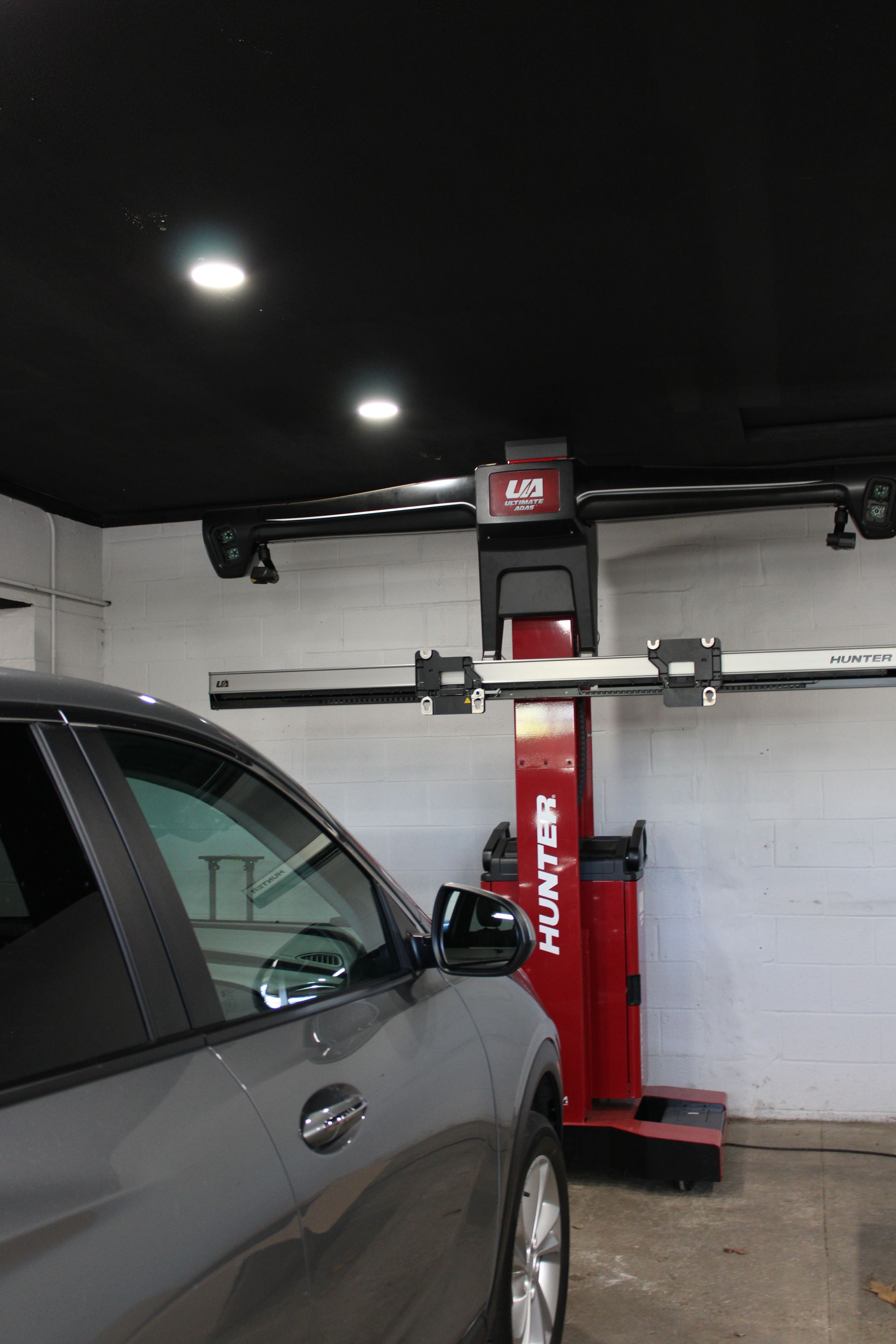 Technician connecting OBD diagnostic equipment to vehicle during ADAS pre-scan