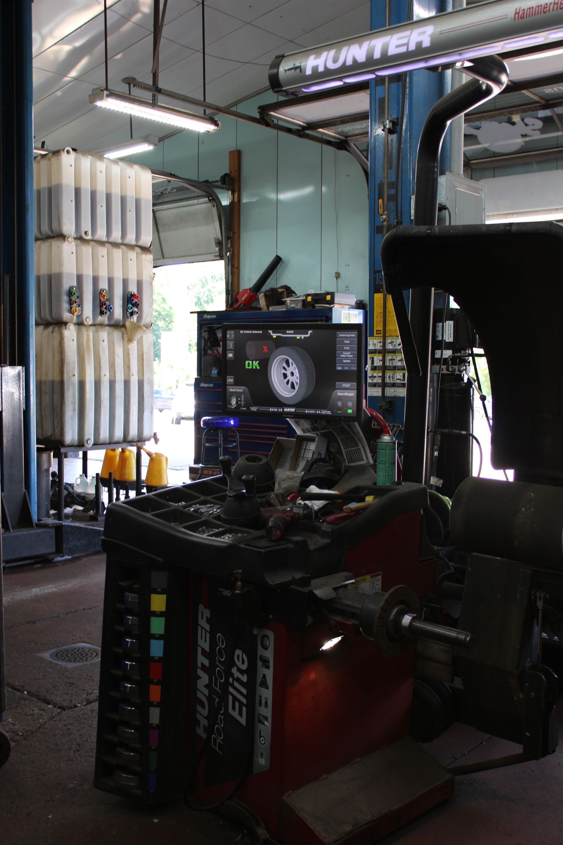 Technician positioning ADAS radar calibration target in front of vehicle