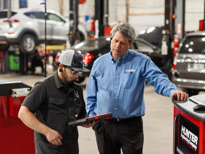 Technician reviewing calibration diagnostic data on laptop