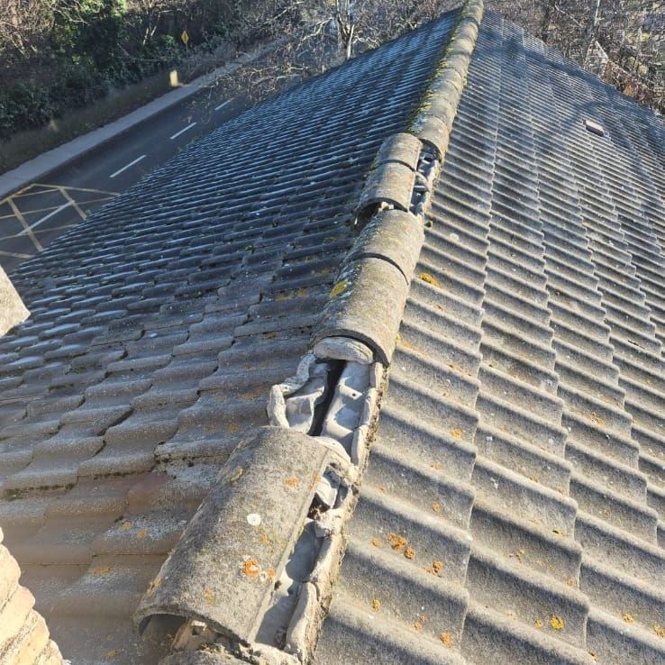 A roof with a lot of tiles on it and a road in the background.