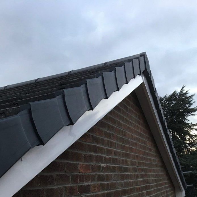 A brick building with a roof that has shingles on it
