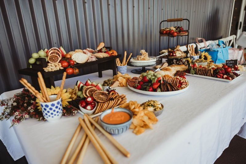 A buffet table with a variety of food on it.