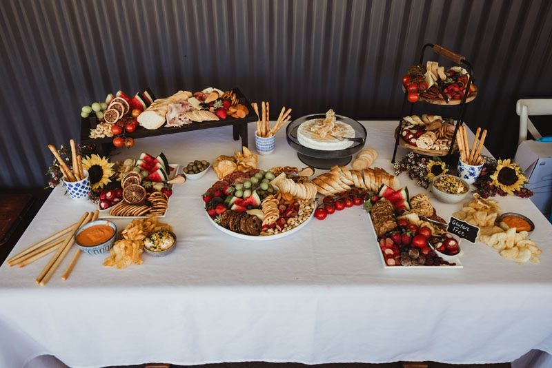 A table with a lot of food on it and a white table cloth.