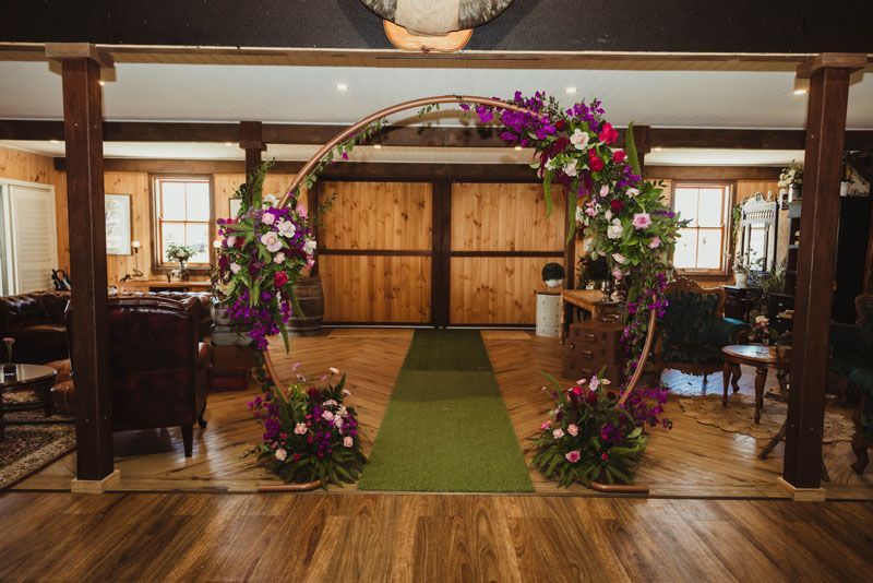 There is a floral arch in the middle of the room.