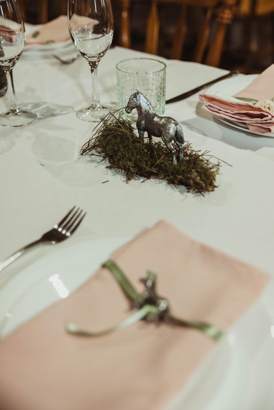 A table with a statue of a horse on it.