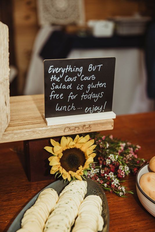 A table with a sign that says everything but the couscous salad is gluten free for today 's lunch.