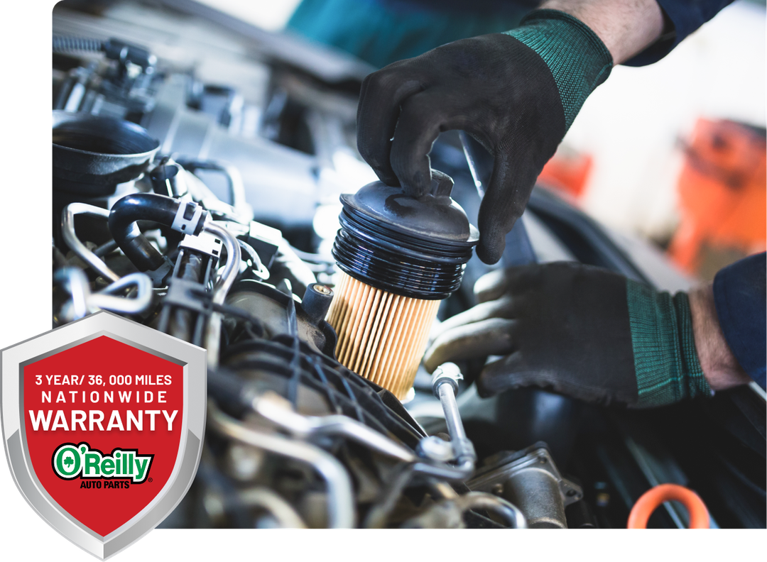 Black automatic transmission on a workbench; person working on the side. | Don's Performance Corner