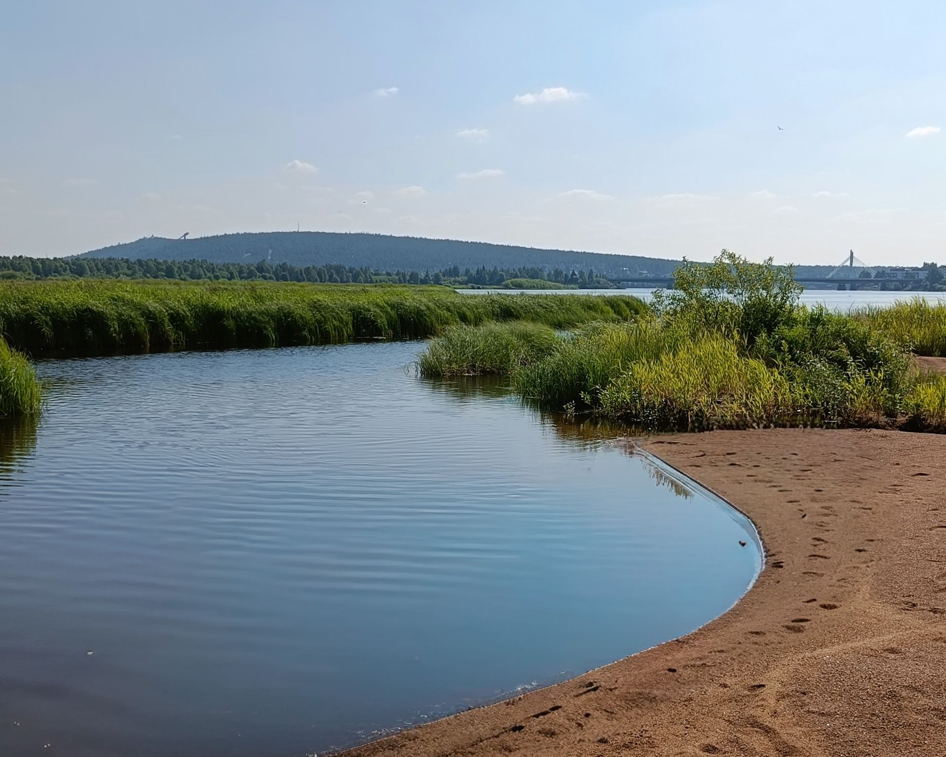Ounasvaara hill and sandy banks of Ounasjoki river with blue skies