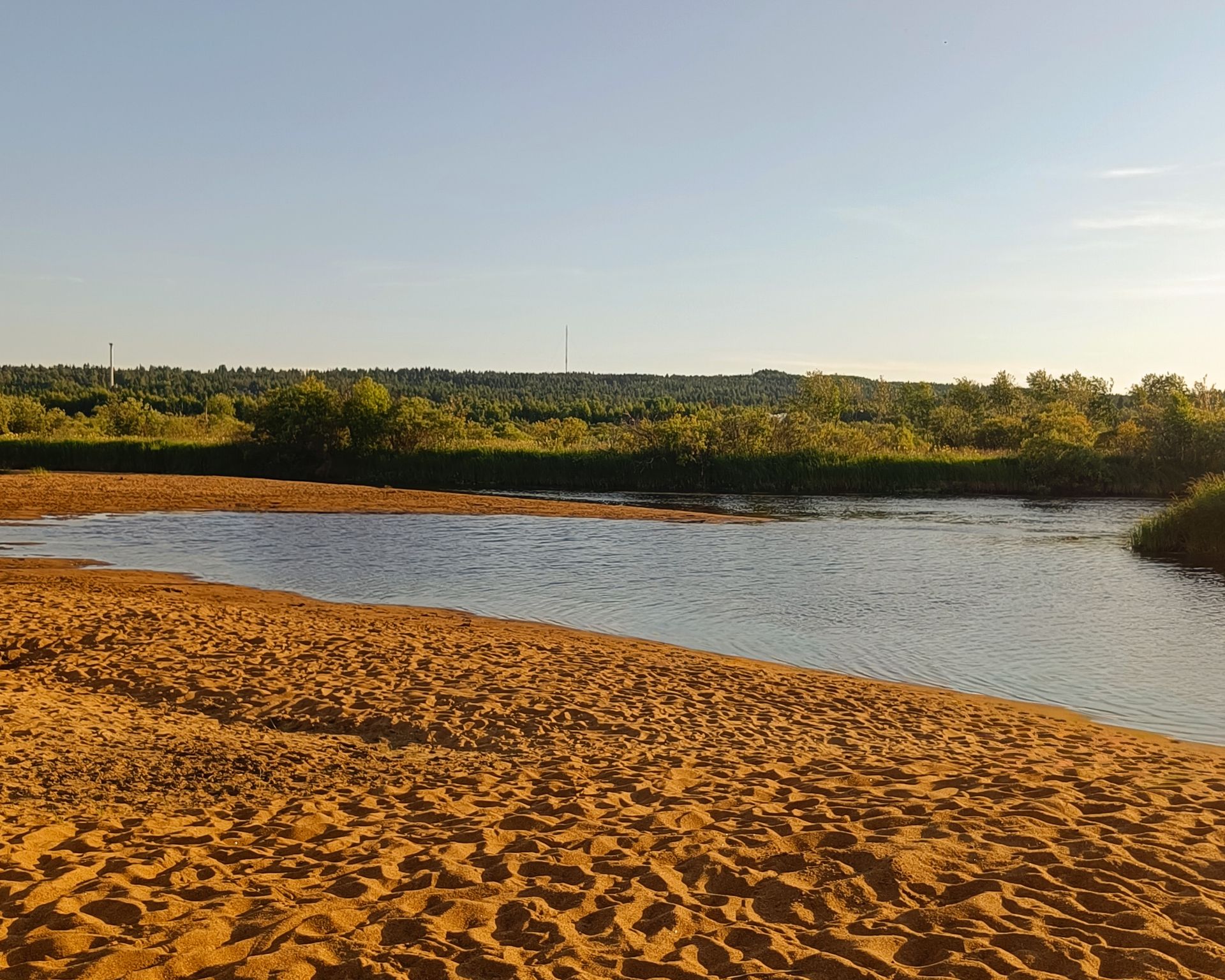 Ounasjoki River and sandy beach with blue sky