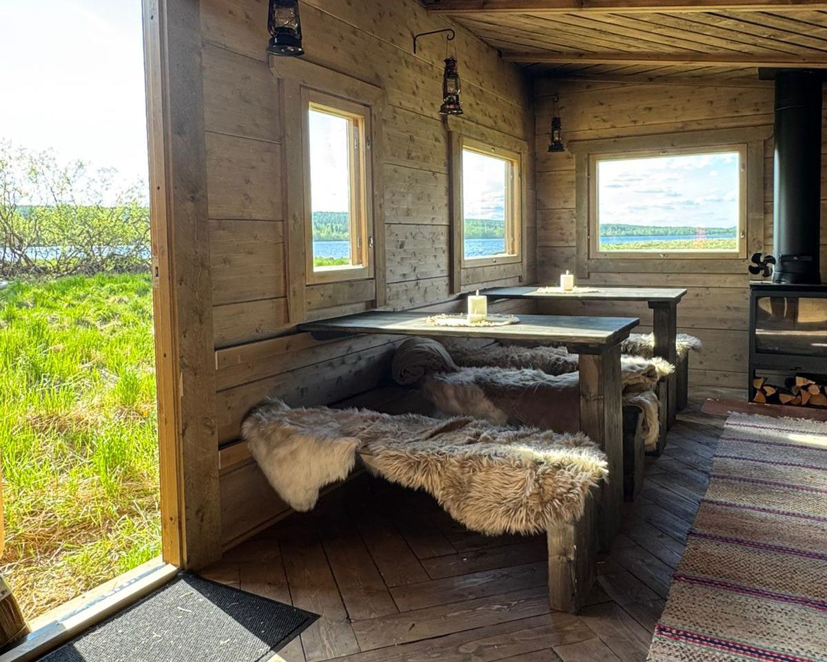 Lush green river valley views from a log cabin with fireplace