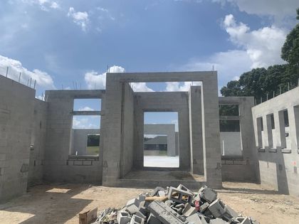 fully built concrete home interior with open doorways masonry under a blue sky