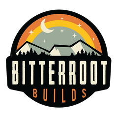 BITTERROOT BUILDS logo with mountain silhouette, sun, moon, and pine trees in orange and cream