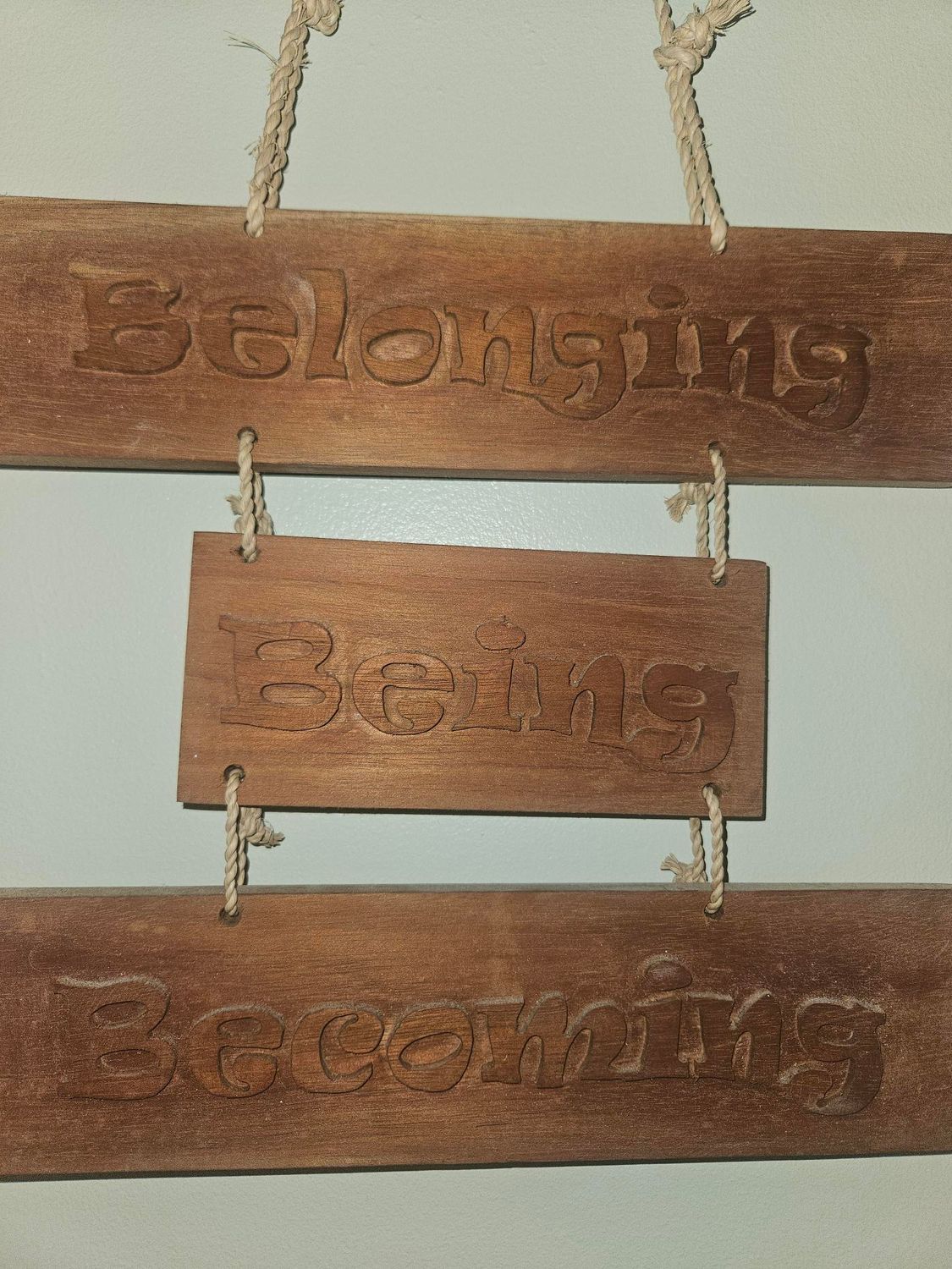 A wooden sign that says belonging hanging on a rope  — Gap Community Early Learning Centre In The Gap, NT