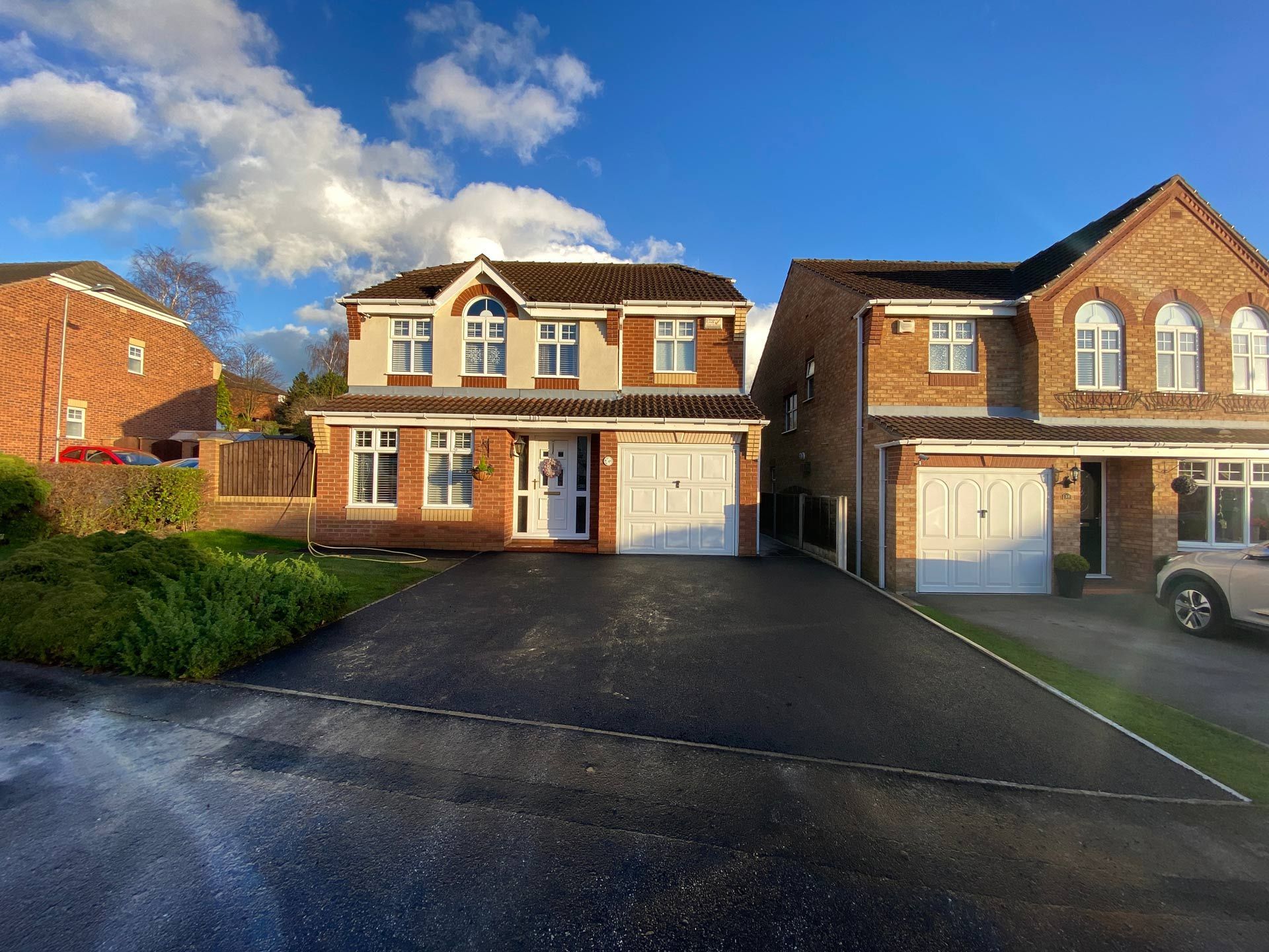 a brick house with a car parked in front of it