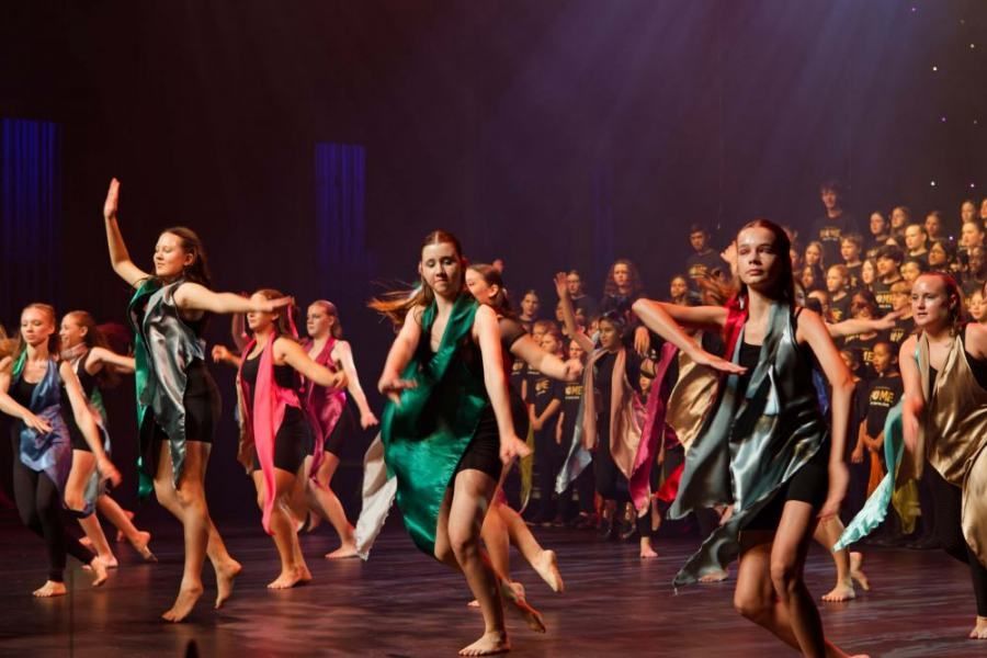 A group of young women are dancing on a stage.