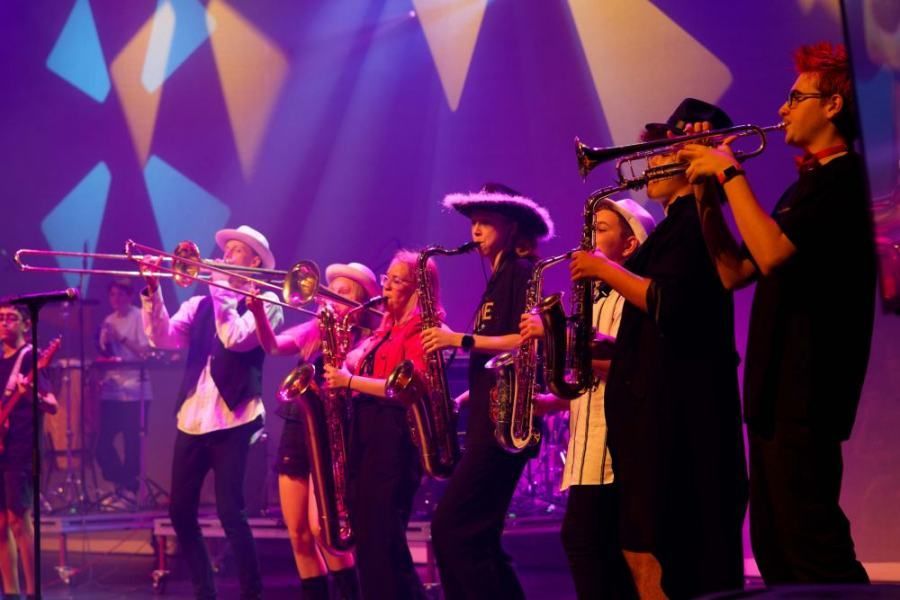A group of people are playing instruments on a stage