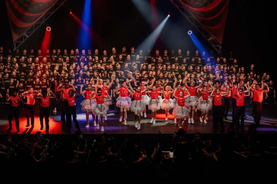 A large group of people are standing on a stage.