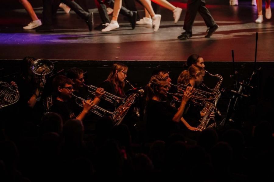 A group of people are playing instruments on a stage.