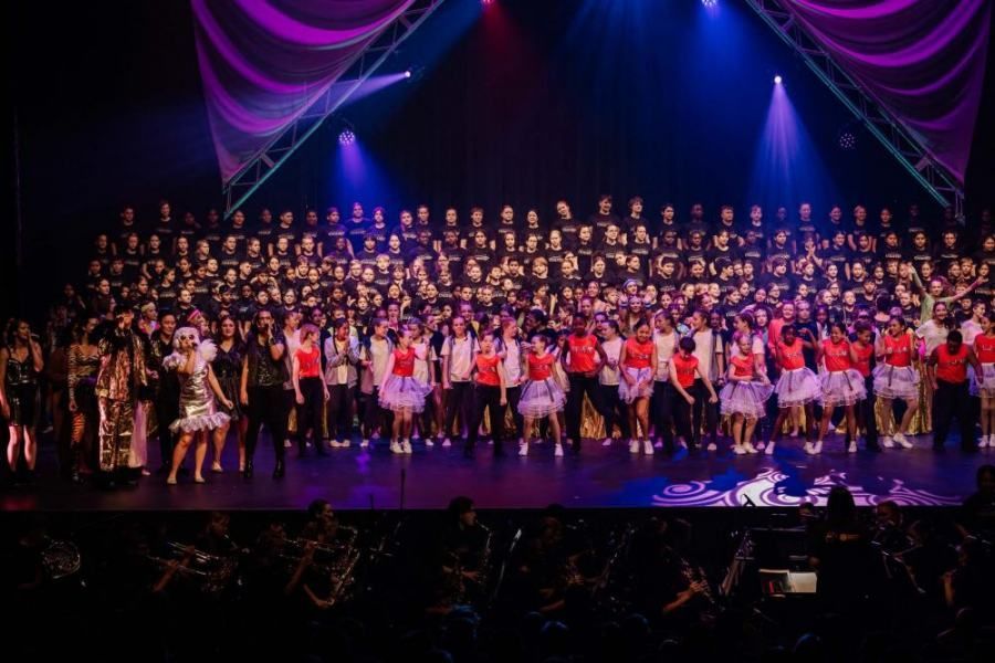 A large group of people are standing on a stage.