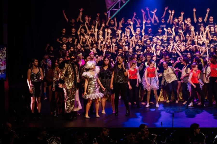 A large group of people are standing on a stage.