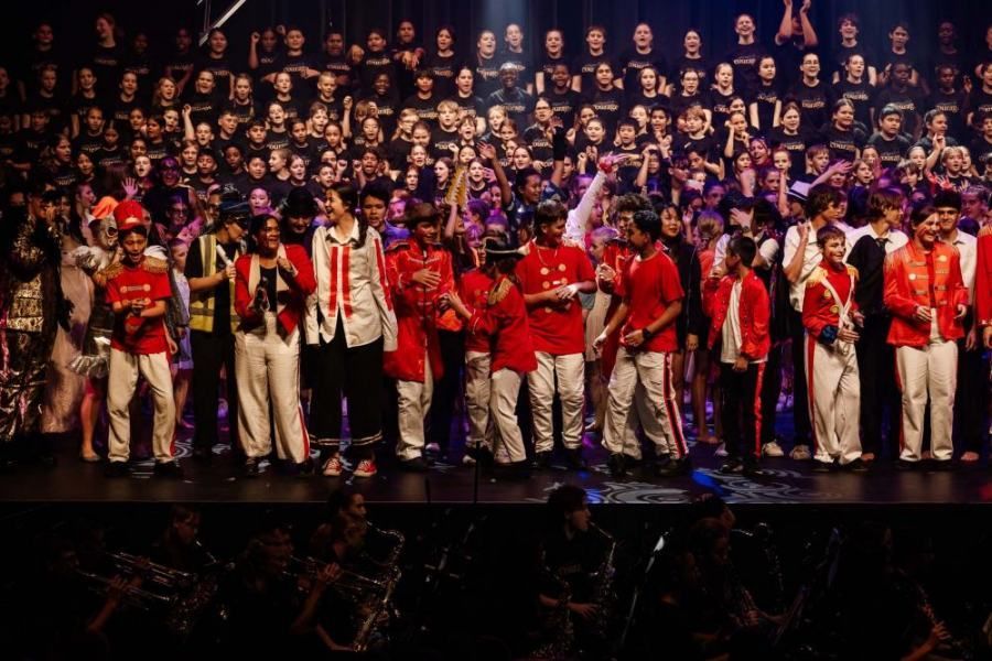 A large group of people are standing on a stage.