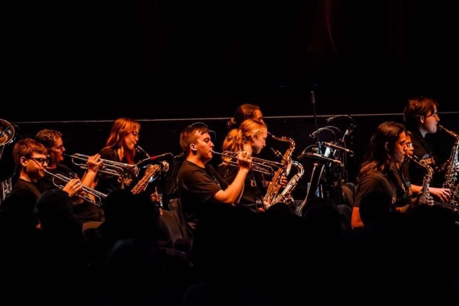 A group of people are playing instruments on a stage.