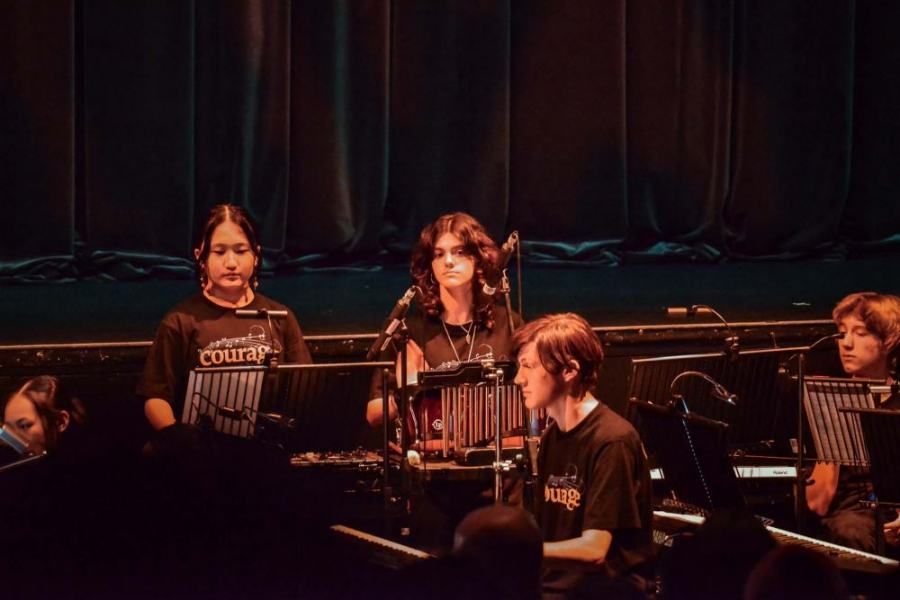A group of people are playing instruments on a stage.