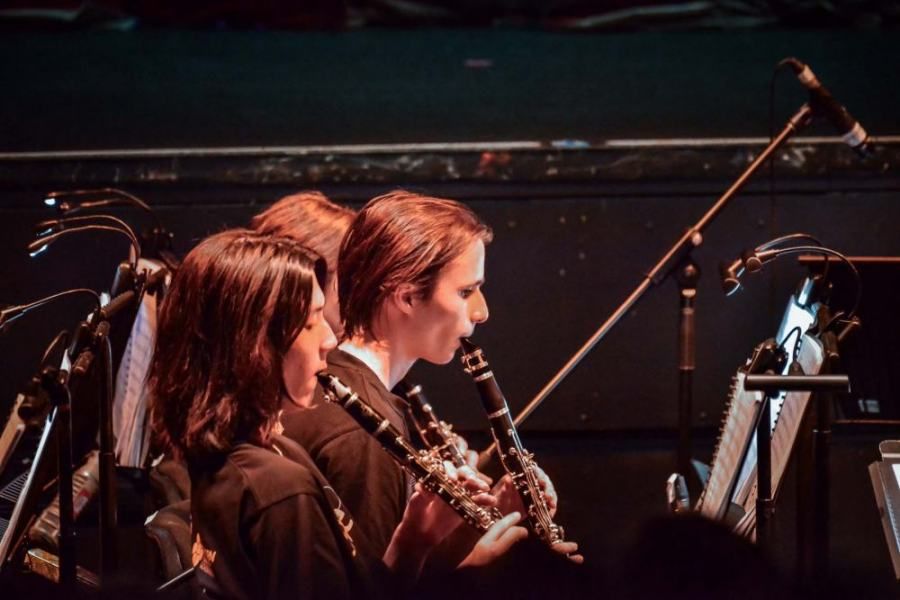 A group of people are playing instruments on a stage.