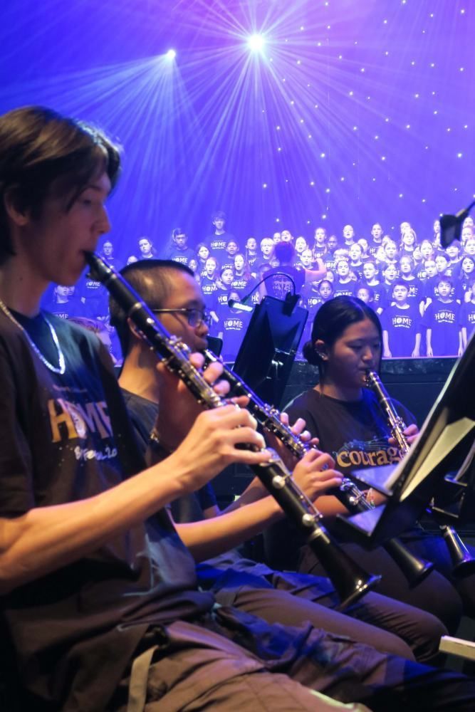 A group of people are playing clarinets on a stage
