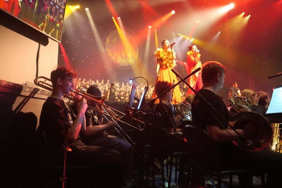 A group of people are playing instruments on a stage.