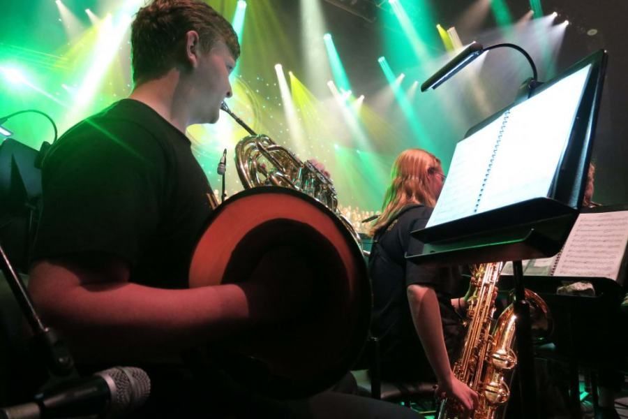 A man is playing a musical instrument on a stage