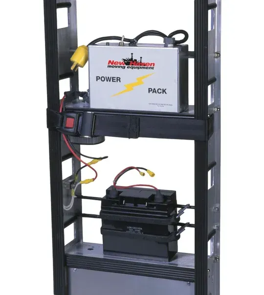 A metal rack holding a battery power pack with an electrical outlet and a lower battery.