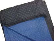 A folded blue and black moving blanket with a zigzag quilted pattern.