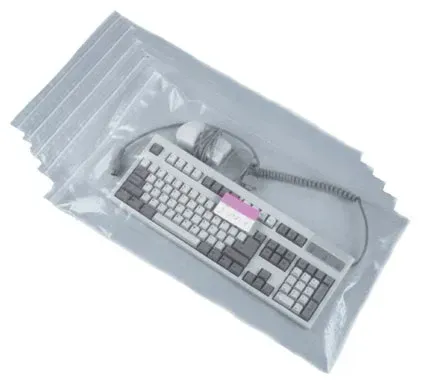 Keyboard and mouse inside clear plastic bags. Several bags visible, stacked diagonally.