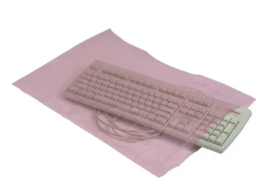 Pink anti-static bag containing a keyboard with a white numeric pad and attached cord.