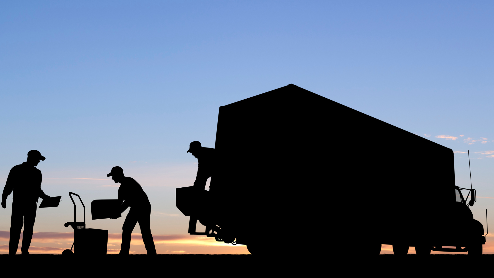 A group of men are loading boxes into a truck.