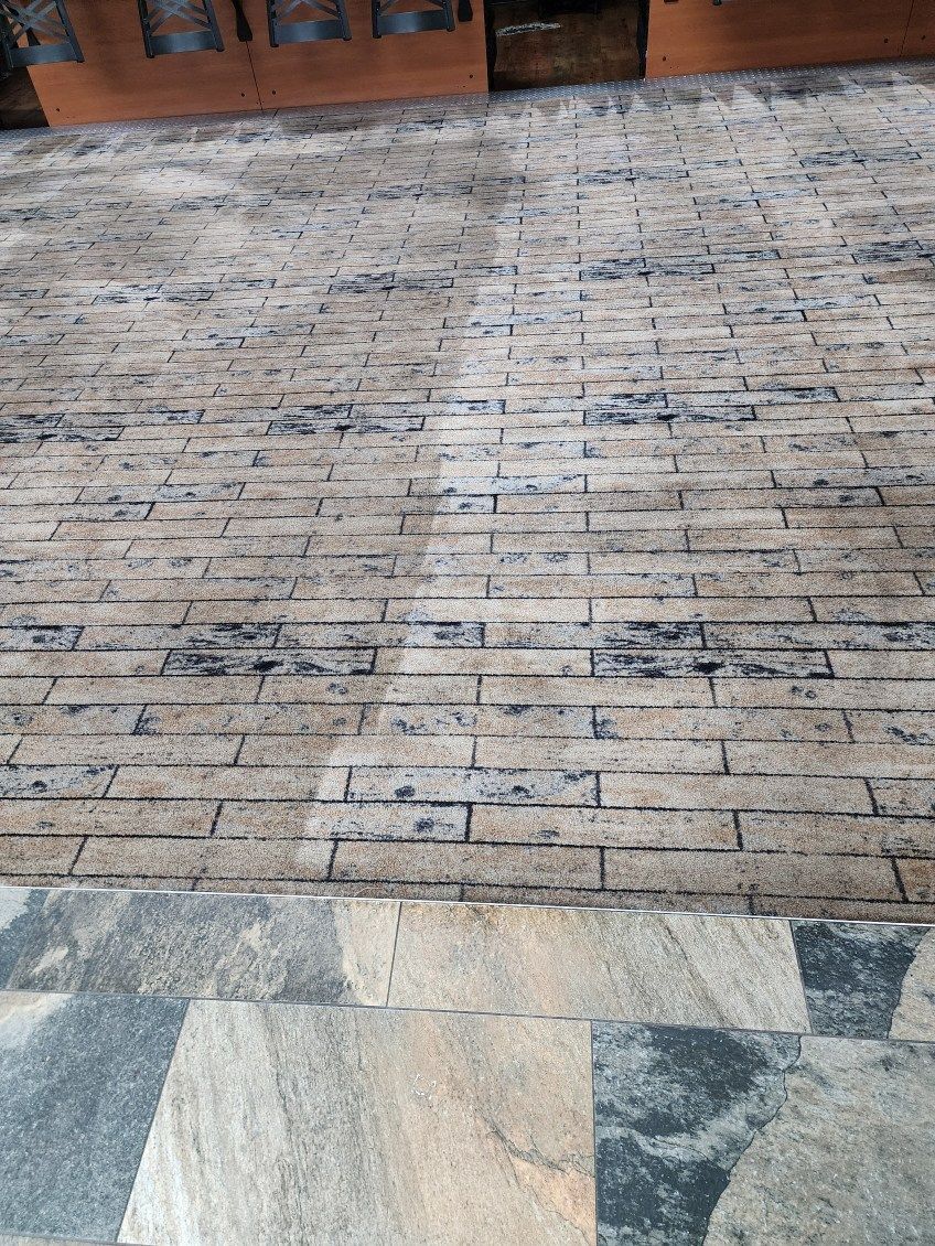 Stone and brick patio leading to a wooden structure at the top edge.