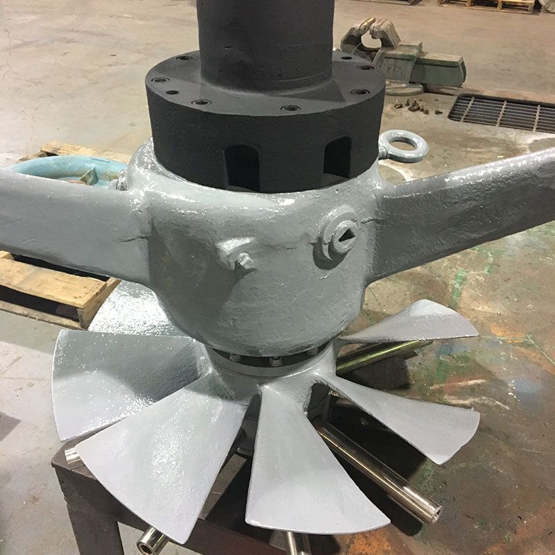 Industrial mixer with gray blades and black hub on a workshop floor